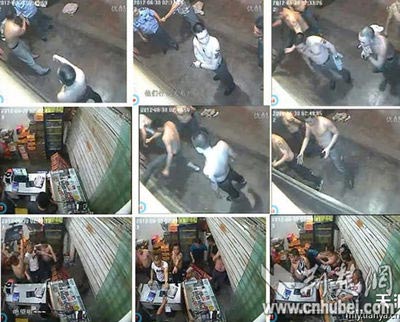 武汉协警旁观嫌犯 打砸小店 被指警匪一家 警方